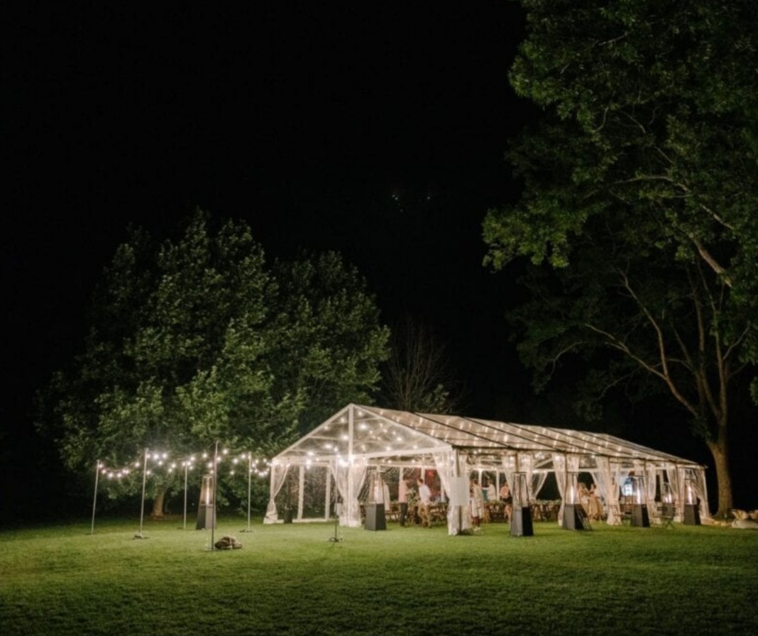 Marquee lit with festoon lights at night